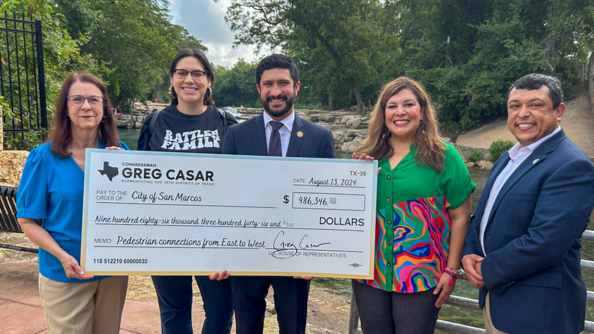 (L-R) San Marcos Mayor Jane Hughson, City Council Member Alyssa Garza, Congressman Greg Casar, City Manager Stephanie Reyes, and City Council Member Matthew Mendoza pose with the $980K+ check for pedestrian connections. (Photo courtesy Office of Congressman Greg Casar)