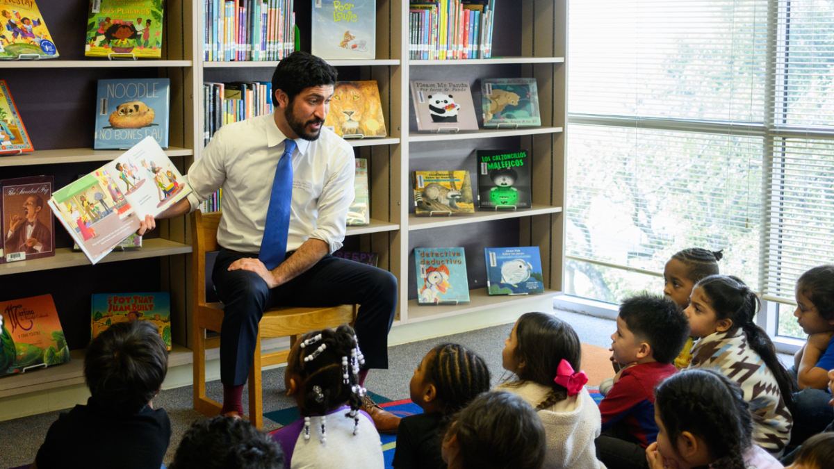 Congressman Casar reading a book to local elementary school students