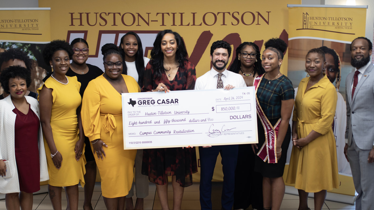 Congressman Greg Casar poses with Huston-Tillotson leadership and students with a big check