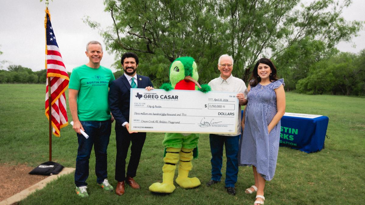 Congressman Greg Casar with Austin officials presenting a big check