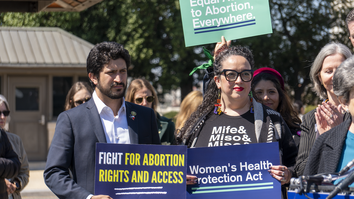 Congressman Greg Casar holds a sign at the official introduction of the Women’s Health Protection Act of 2023.
