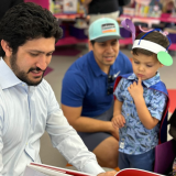 Congressman Greg Casar reads to a student in San Antonio
