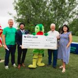 Congressman Greg Casar with Austin officials presenting a big check