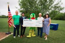 Congressman Greg Casar with Austin officials presenting a big check